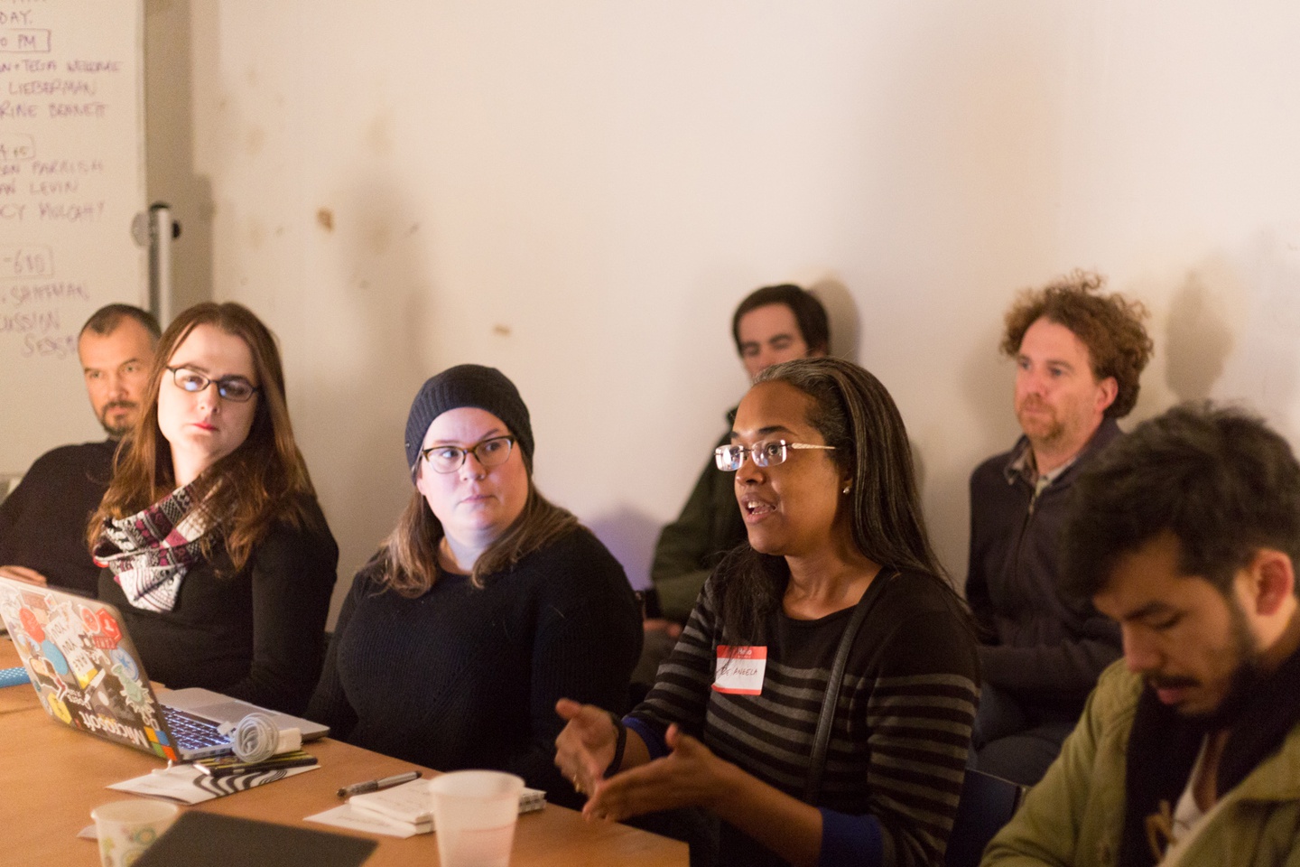 woman speaks while others sitting nearby listen